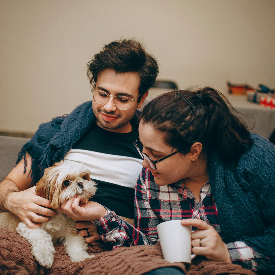 Couple relaxing with small dog